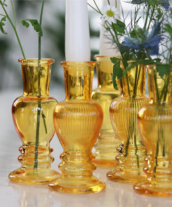 Gold Multi-Use Glass Vase and Candle Holder Set, chosen by master florist Lamber De Bie. This set of six exquisite gold-hued glass vases, available in two sizes, adds a touch of opulence to any setting